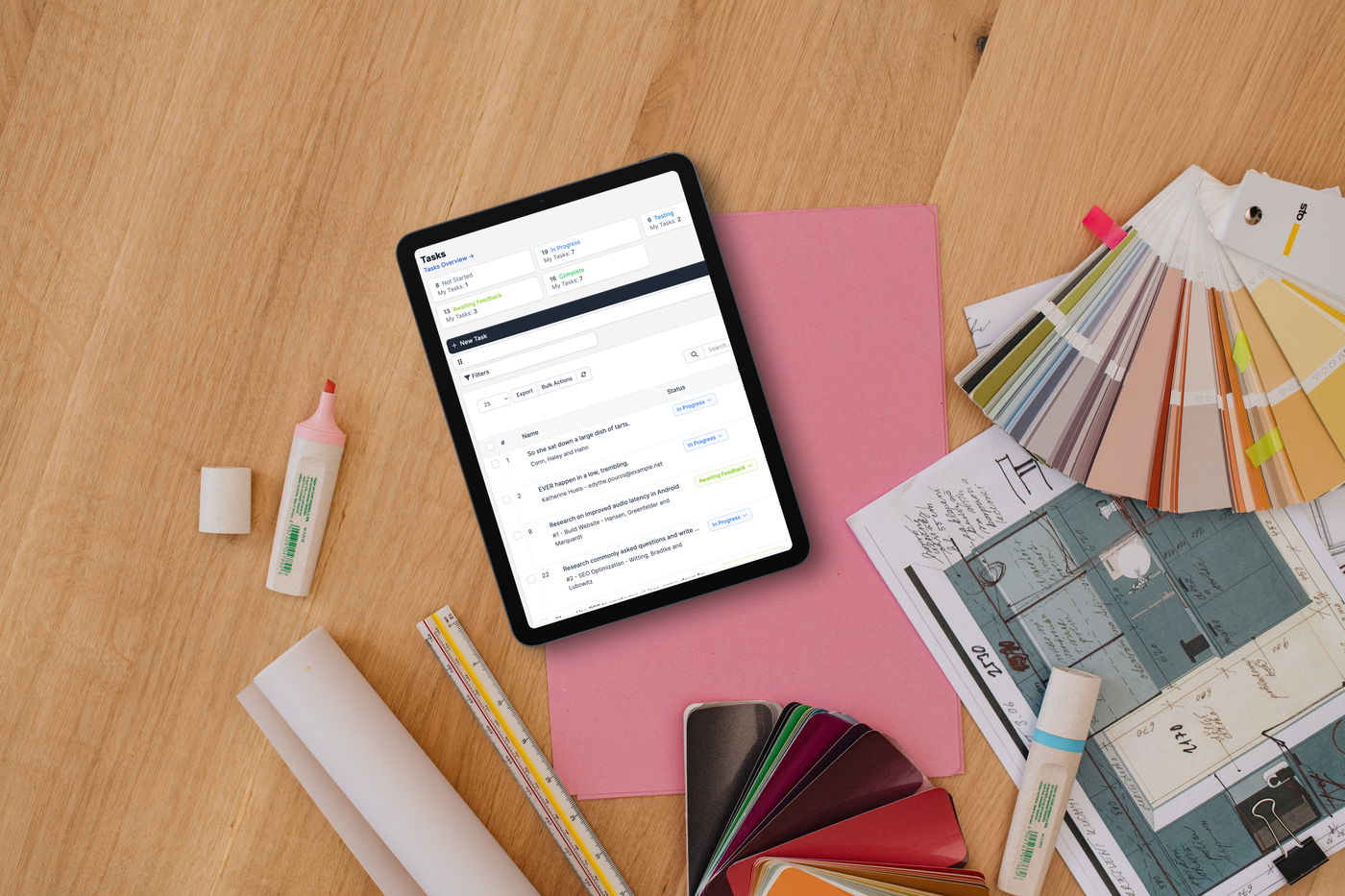 Custom CRM dashboard design displayed on tablet with architect materials